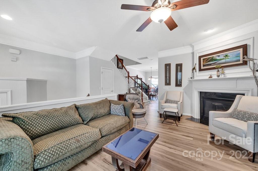 584 6th Baxter Crossing Fort Mill, SC 29708 - Photo 5 of 21 a living room with furniture a flat screen tv and a fireplace