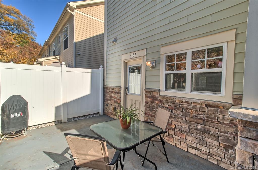 4136 Walker Road Charlotte, NC 28211 - Photo 12 of 15 a backyard of a house with table and chairs