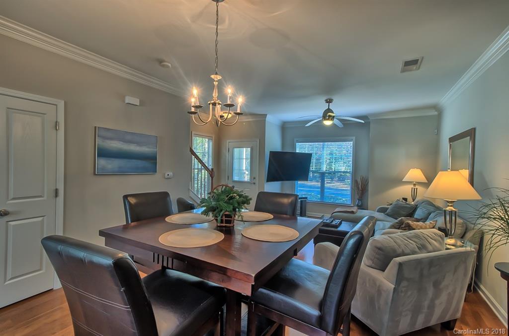 4136 Walker Road Charlotte, NC 28211 - Photo 4 of 15 a view of a dining room with furniture and a chandelier