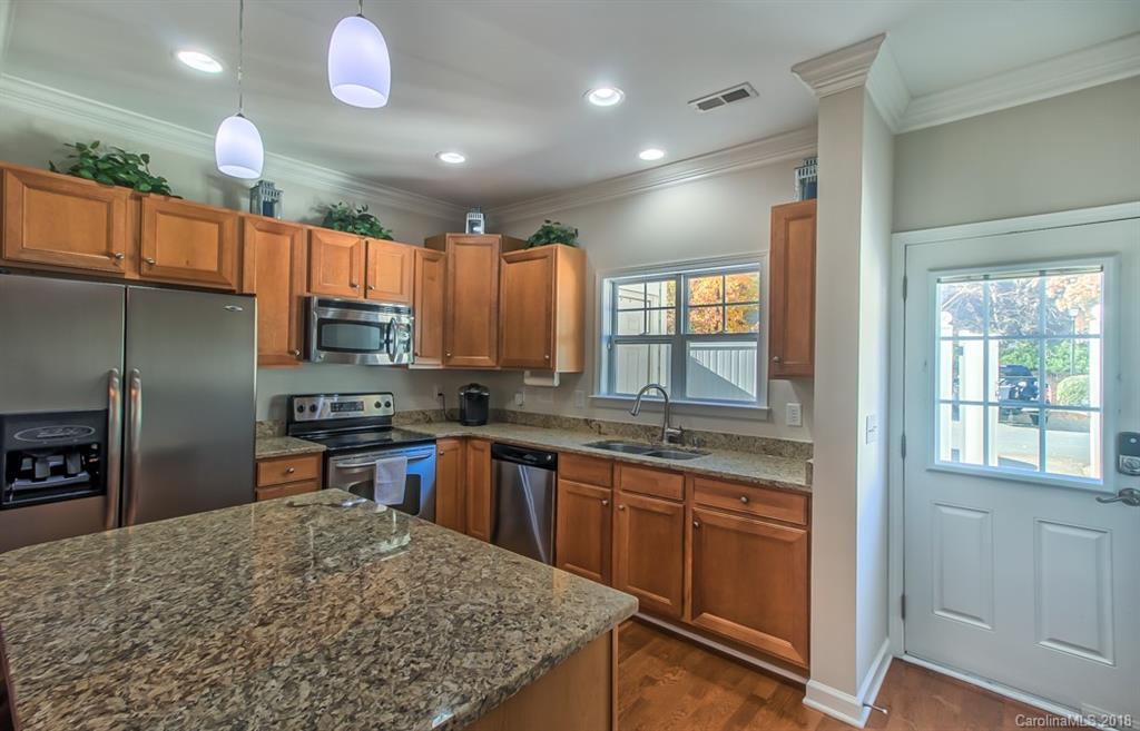 4136 Walker Road Charlotte, NC 28211 - Photo 5 of 15 a kitchen with stainless steel appliances granite countertop a sink stove and refrigerator