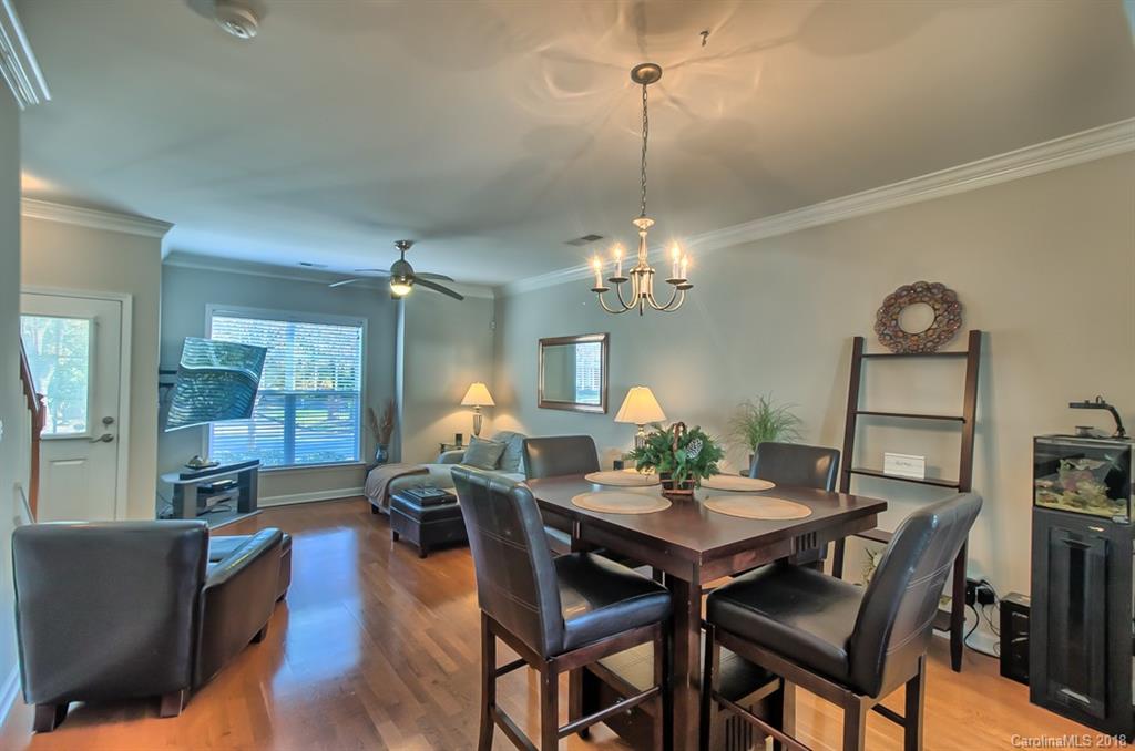 4136 Walker Road Charlotte, NC 28211 - Photo 6 of 15 a view of a dining room with furniture a chandelier and wooden floor