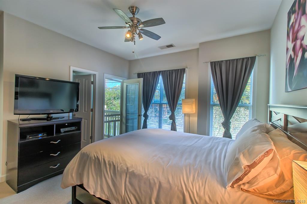 4136 Walker Road Charlotte, NC 28211 - Photo 7 of 15 a bedroom with a bed and a flat screen tv