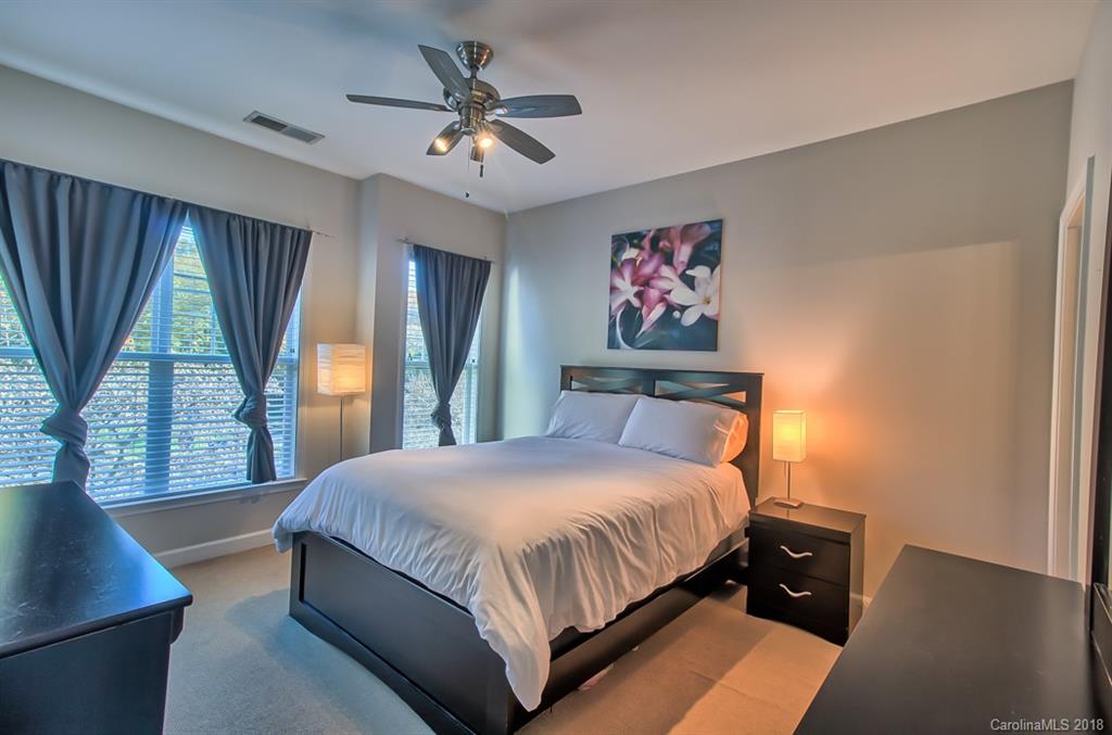 4136 Walker Road Charlotte, NC 28211 - Photo 8 of 15 a bedroom with a large bed and a chandelier