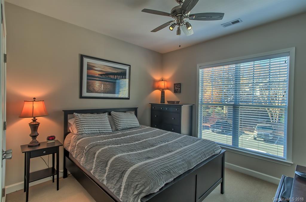4136 Walker Road Charlotte, NC 28211 - Photo 10 of 15 a bedroom with a bed and a chandelier