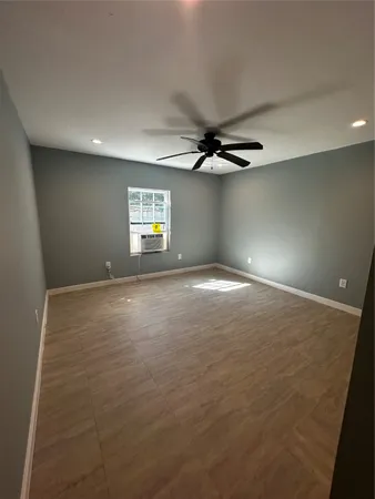 a view of a livingroom with a ceiling fan and window
