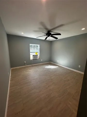 a view of a livingroom with a ceiling fan and window