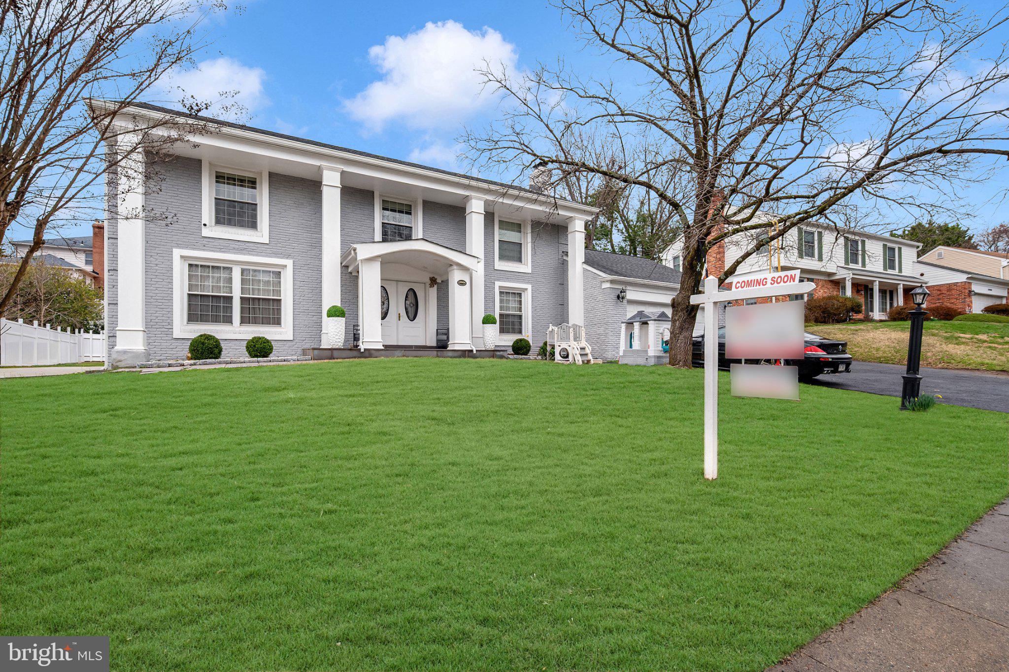 Charming gray residence with lush lawn.
