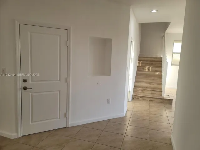 a view of a hallway with closet and mirror