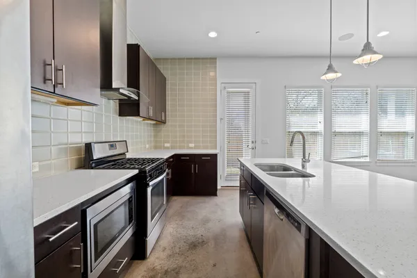 a kitchen with a sink stove and microwave