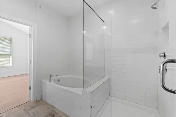 a white bath tub sitting next to a shower