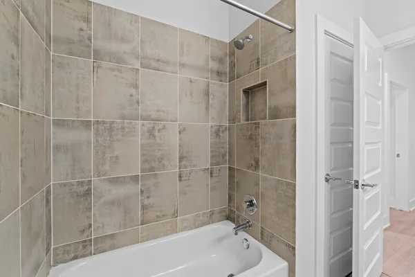 a bathroom with a bathtub and a shower
