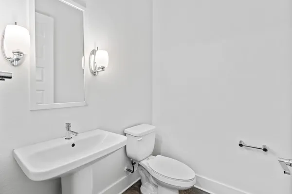 a white toilet sitting next to a bathroom sink