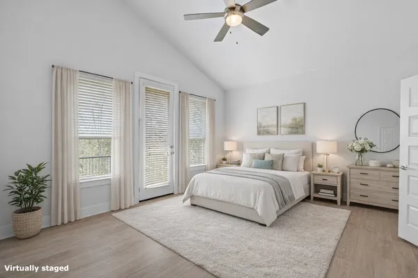 a bedroom with bed and ceiling fan
