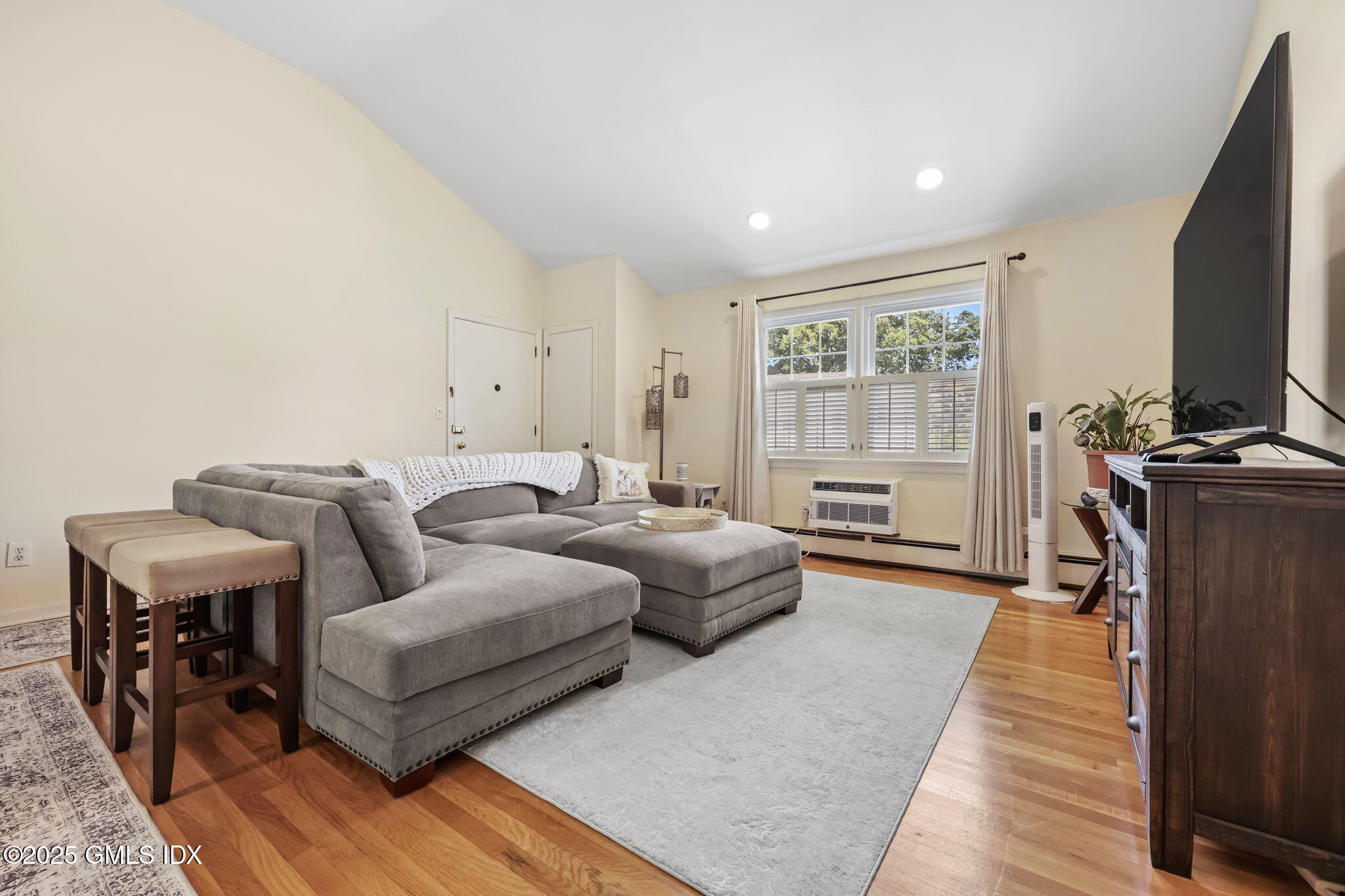 47 Valley Road, Unit B3 Cos Cob, CT 06807 - Photo 3 of 18 a spacious bedroom with two beds and a flat screen tv