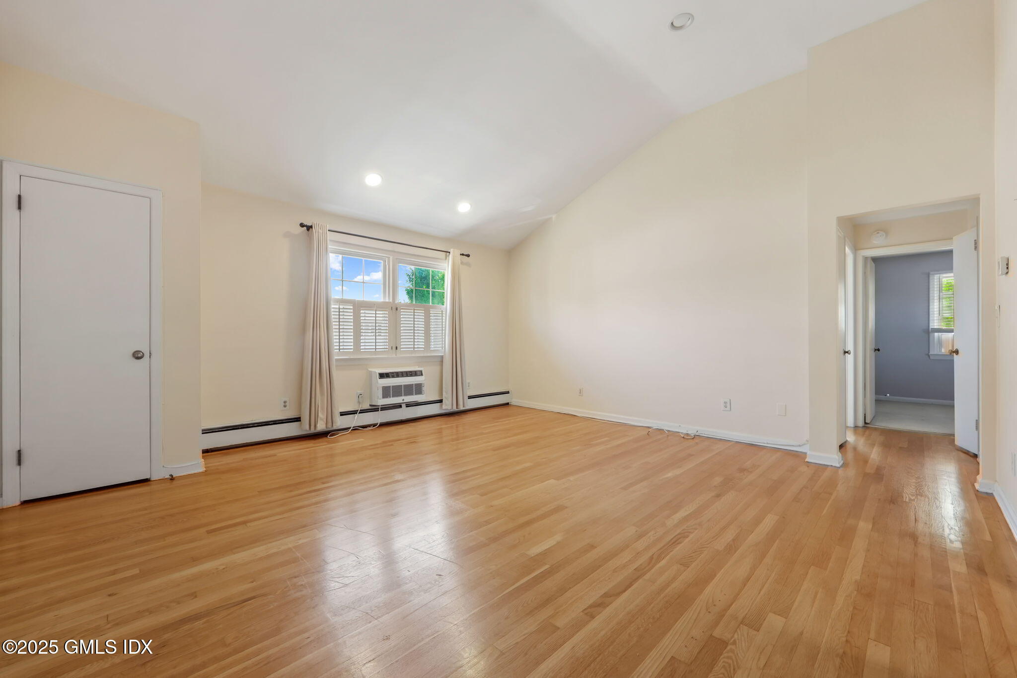 47 Valley Road, Unit B3 Cos Cob, CT 06807 - Photo 4 of 18 a view of an empty room with wooden floor and window