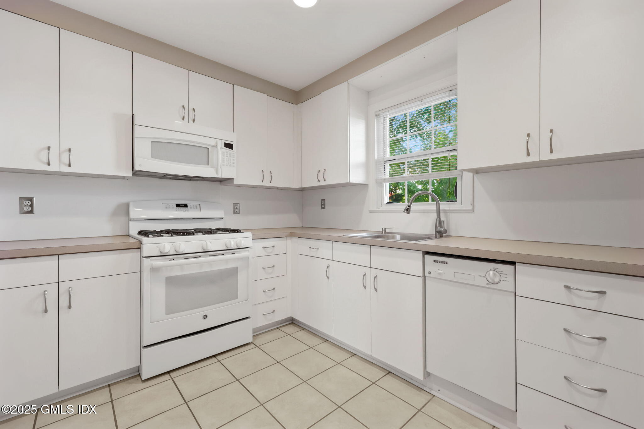 47 Valley Road, Unit B3 Cos Cob, CT 06807 - Photo 7 of 18 a kitchen with cabinets appliances a sink and a window