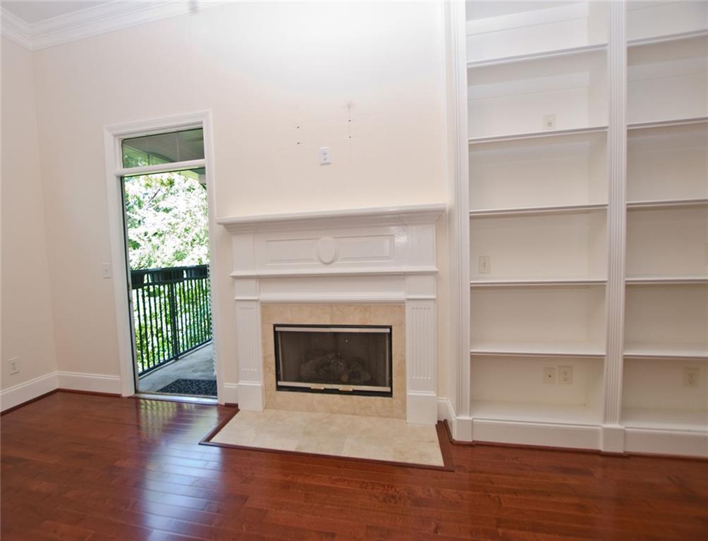 4100 Paces Walk Southeast, Unit 1305 Atlanta, GA 30339 - Photo 12 of 45 a living room with a fireplace and wooden floor