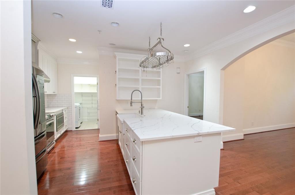4100 Paces Walk Southeast, Unit 1305 Atlanta, GA 30339 - Photo 18 of 45 a kitchen with a sink appliances and a counter top space