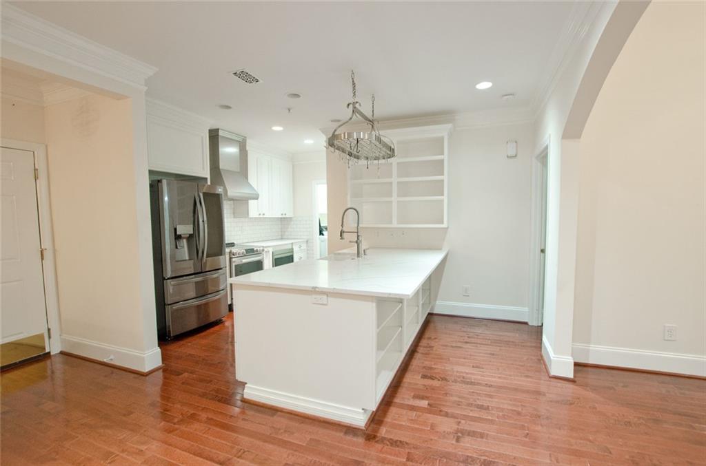 4100 Paces Walk Southeast, Unit 1305 Atlanta, GA 30339 - Photo 19 of 45 a kitchen with kitchen island a sink a stove a refrigerator and cabinets