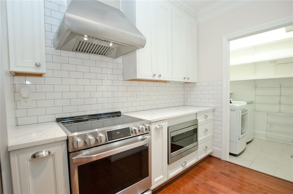 4100 Paces Walk Southeast, Unit 1305 Atlanta, GA 30339 - Photo 24 of 45 a stove top oven sitting inside of a kitchen