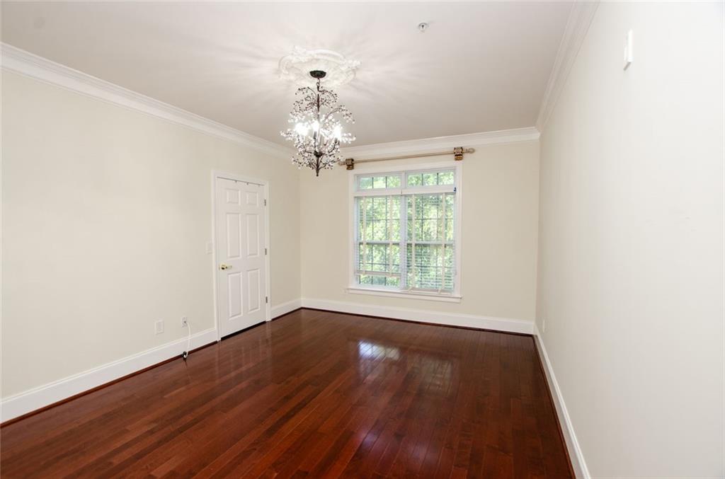 4100 Paces Walk Southeast, Unit 1305 Atlanta, GA 30339 - Photo 25 of 45 an empty room with wooden floor and windows