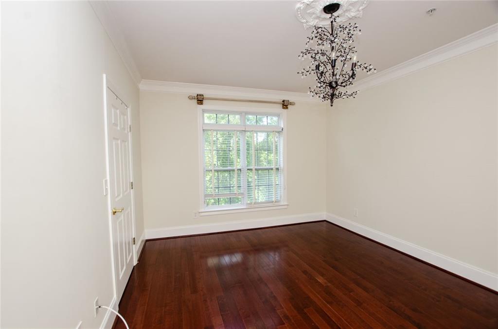 4100 Paces Walk Southeast, Unit 1305 Atlanta, GA 30339 - Photo 26 of 45 a view of a room with wooden floor and large window