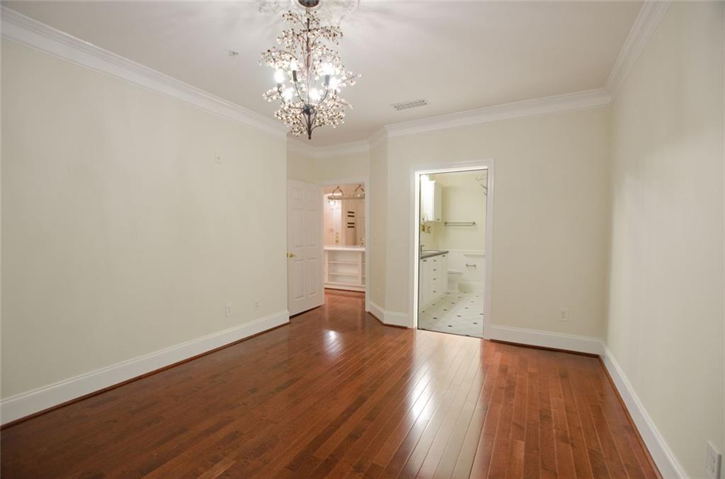4100 Paces Walk Southeast, Unit 1305 Atlanta, GA 30339 - Photo 27 of 45 a view of a hallway with wooden floor and a chandelier