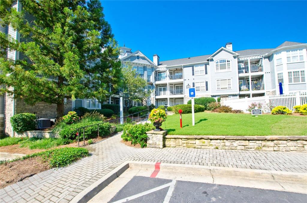 4100 Paces Walk Southeast, Unit 1305 Atlanta, GA 30339 - Photo 3 of 45 a front view of a house with a yard