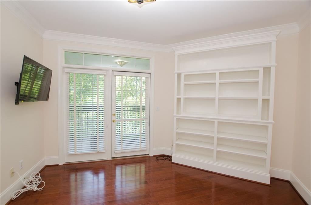 4100 Paces Walk Southeast, Unit 1305 Atlanta, GA 30339 - Photo 33 of 45 a view of an empty room with a window and wooden floor