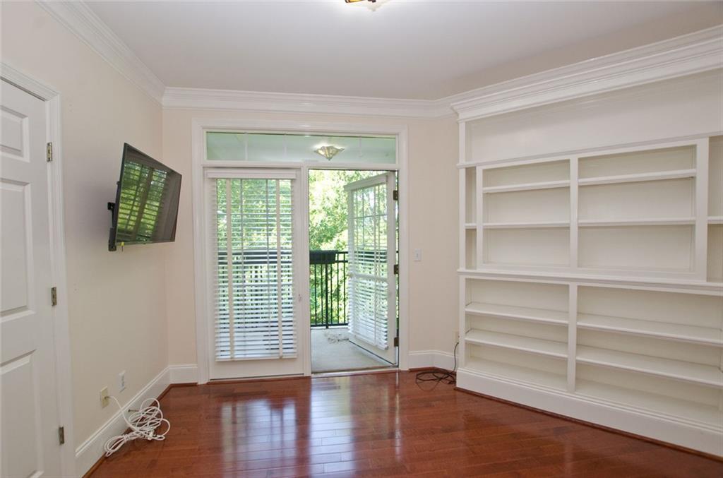 4100 Paces Walk Southeast, Unit 1305 Atlanta, GA 30339 - Photo 35 of 45 a view of an empty room with a window and wooden floor