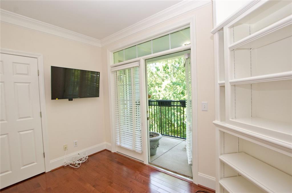 4100 Paces Walk Southeast, Unit 1305 Atlanta, GA 30339 - Photo 36 of 45 a view of a livingroom with wooden floor and a flat screen tv