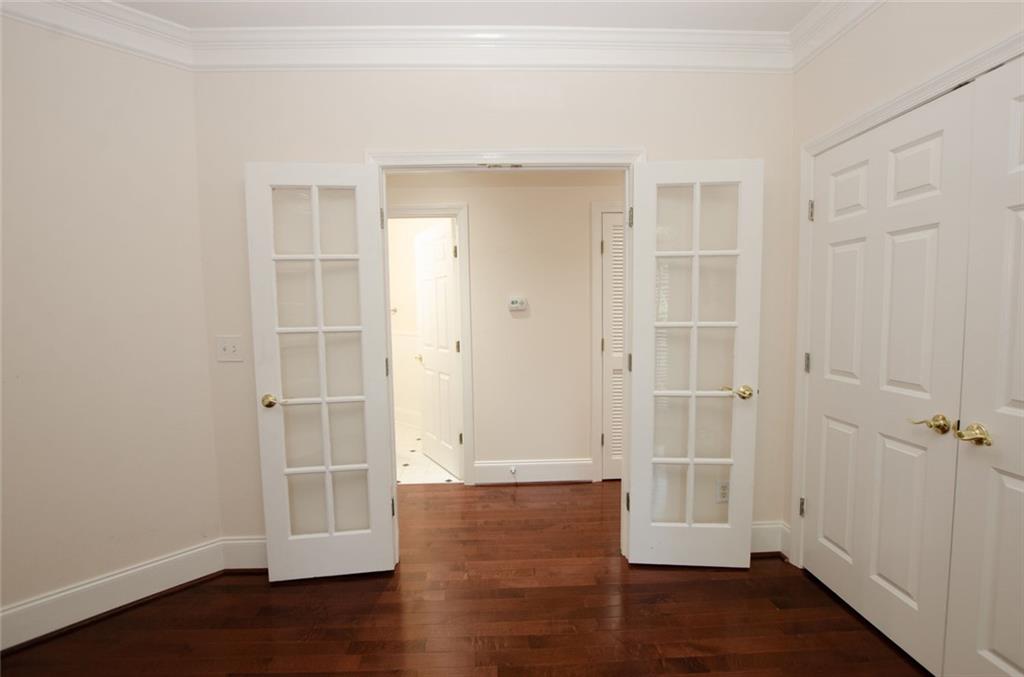 4100 Paces Walk Southeast, Unit 1305 Atlanta, GA 30339 - Photo 37 of 45 an empty room with wooden floor and a window