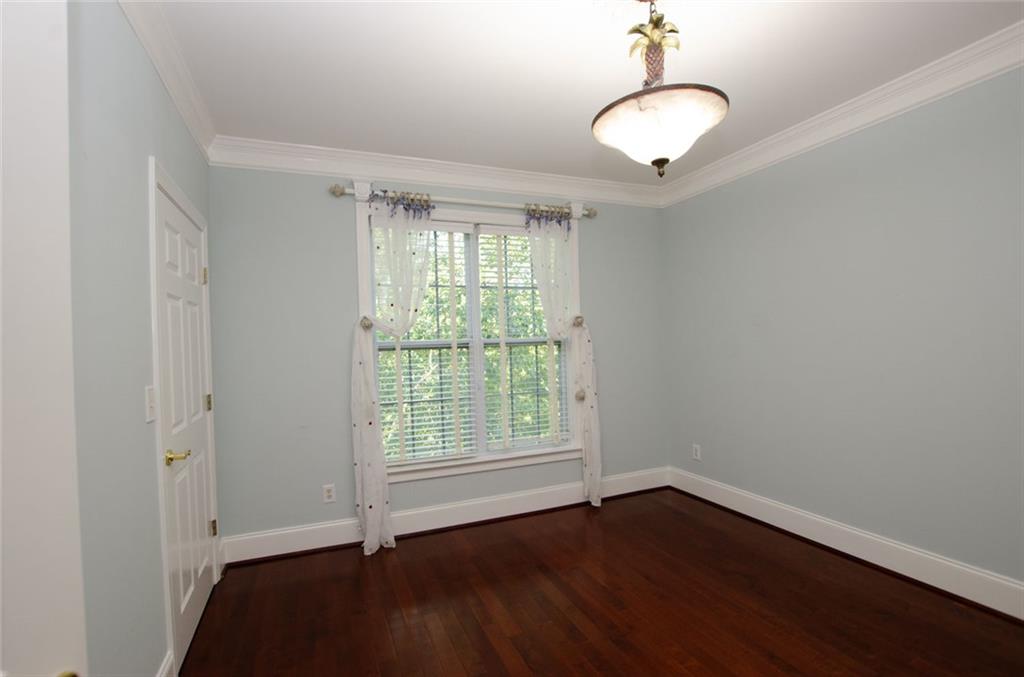 4100 Paces Walk Southeast, Unit 1305 Atlanta, GA 30339 - Photo 38 of 45 wooden floor in an empty room with a window