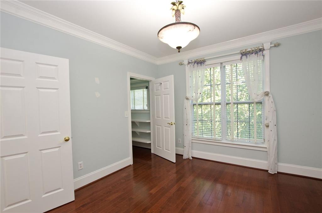 4100 Paces Walk Southeast, Unit 1305 Atlanta, GA 30339 - Photo 40 of 45 wooden floor in an empty room with a window