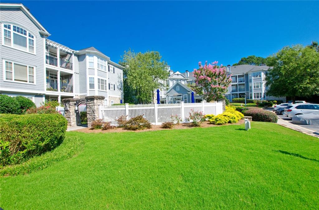 4100 Paces Walk Southeast, Unit 1305 Atlanta, GA 30339 - Photo 4 of 45 a view of a house with backyard sitting area and garden