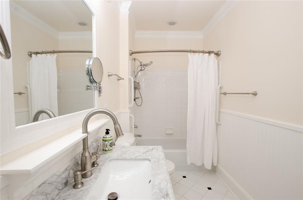 4100 Paces Walk Southeast, Unit 1305 Atlanta, GA 30339 - Photo 41 of 45 a bathroom with a sink and a mirror