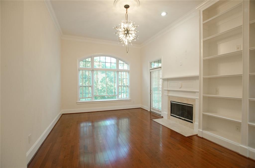 4100 Paces Walk Southeast, Unit 1305 Atlanta, GA 30339 - Photo 7 of 45 a view of a livingroom with a fireplace wooden floor and chandelier