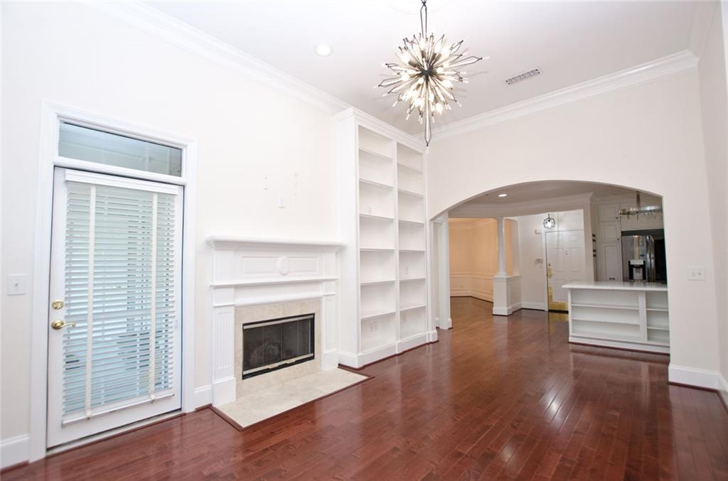 4100 Paces Walk Southeast, Unit 1305 Atlanta, GA 30339 - Photo 10 of 45 a view of an empty room with wooden floor fireplace and a window