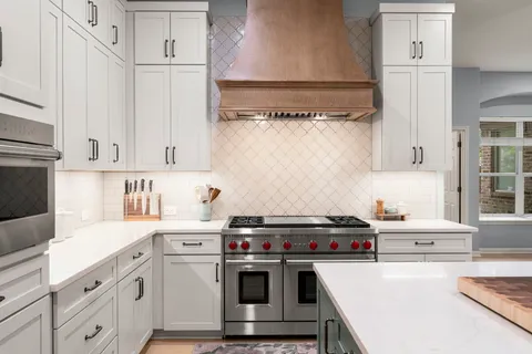 a kitchen with cabinets a stove and a sink