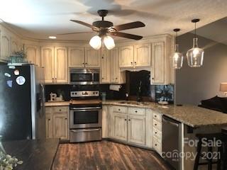 2270 Miller Road Salisbury, NC 28147 - Photo 22 of 33 a kitchen with stainless steel appliances granite countertop a stove a sink and a refrigerator