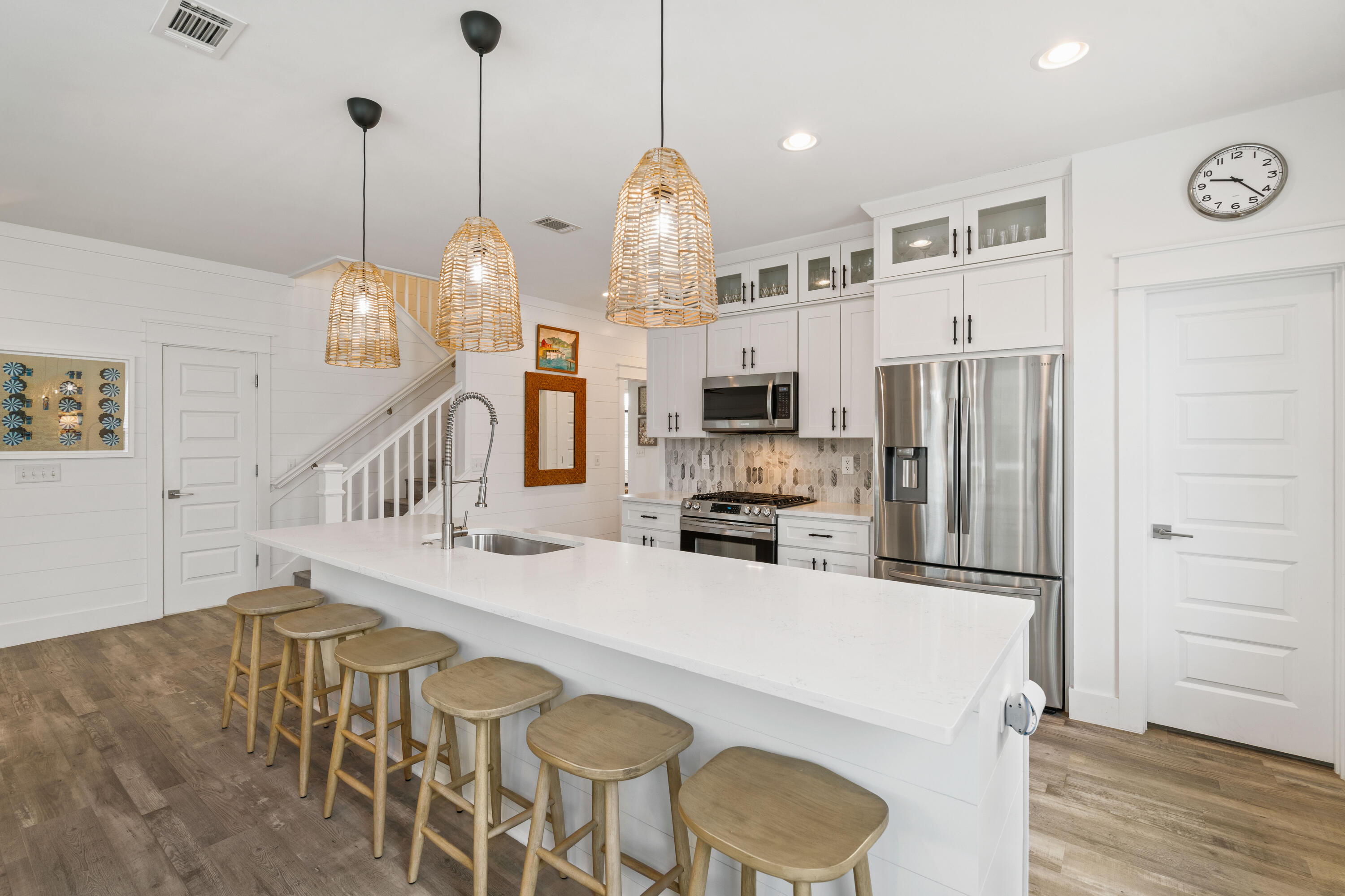 21 Seabreeze Blvd Inlet Beach Inlet Beach, FL 32461 - Photo 13 of 54 a kitchen with stainless steel appliances kitchen island granite countertop a refrigerator a stove top oven a dining table and chairs with wooden floor