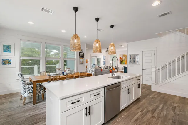 a kitchen with sink stove and wooden floor