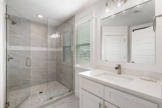 a bathroom with a sink vanity mirror and toilet