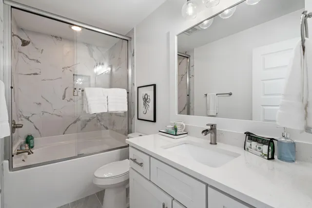 a living room with furniture a flat screen tv and kitchen view