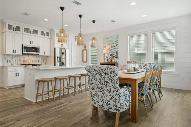 a dining room with furniture and wooden floor
