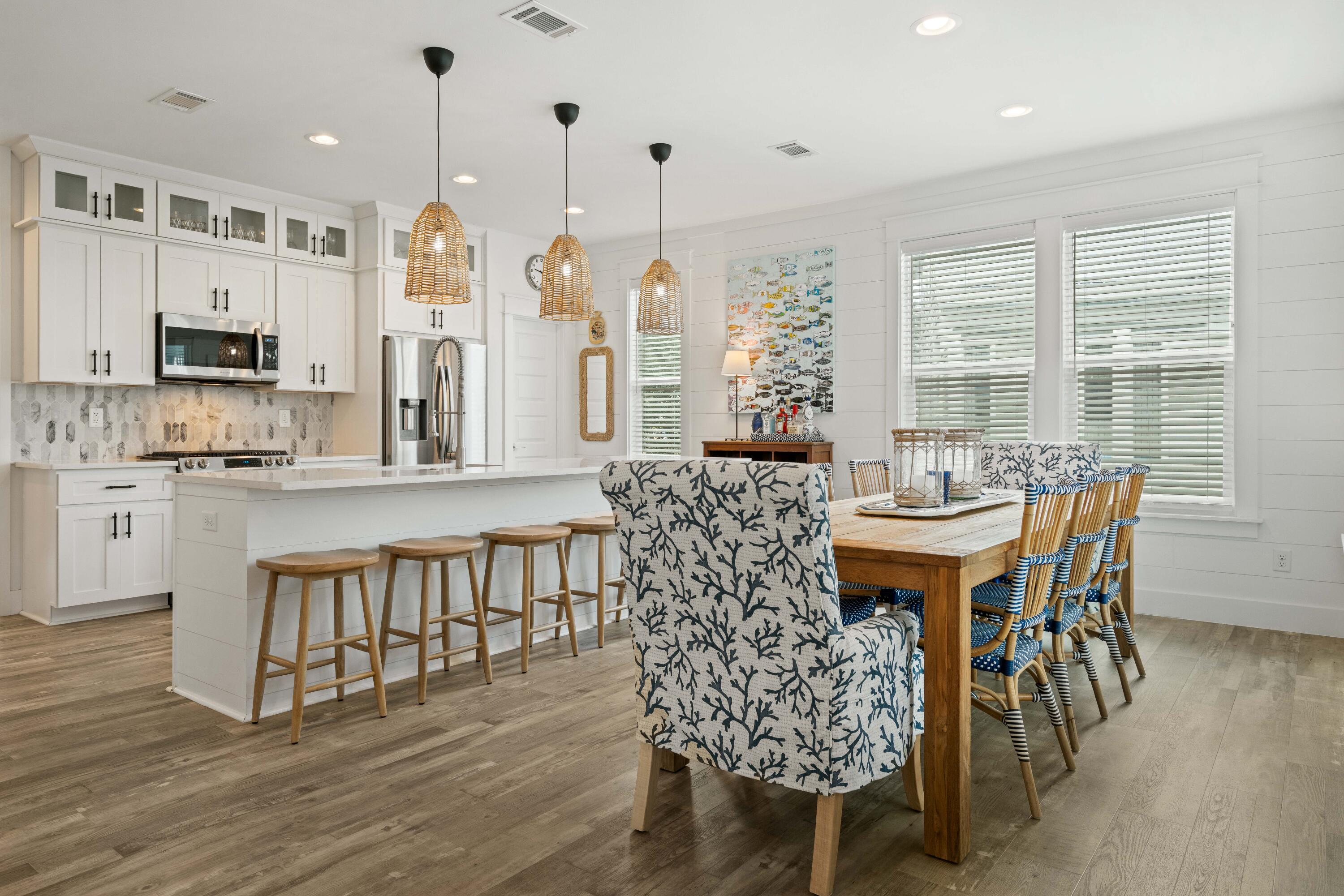 21 Seabreeze Blvd Inlet Beach Inlet Beach, FL 32461 - Photo 6 of 54 a dining room with furniture a chandelier and wooden floor
