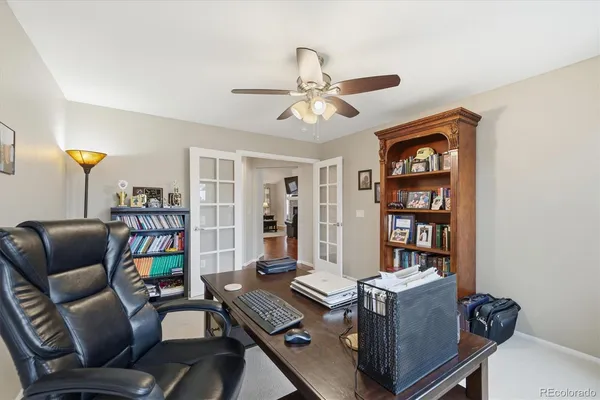a work room with furniture and a bookshelf