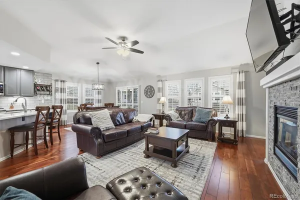 a living room with furniture wooden floor and a fireplace