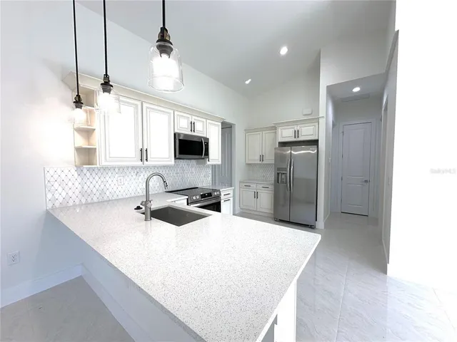 a kitchen with refrigerator and cabinets
