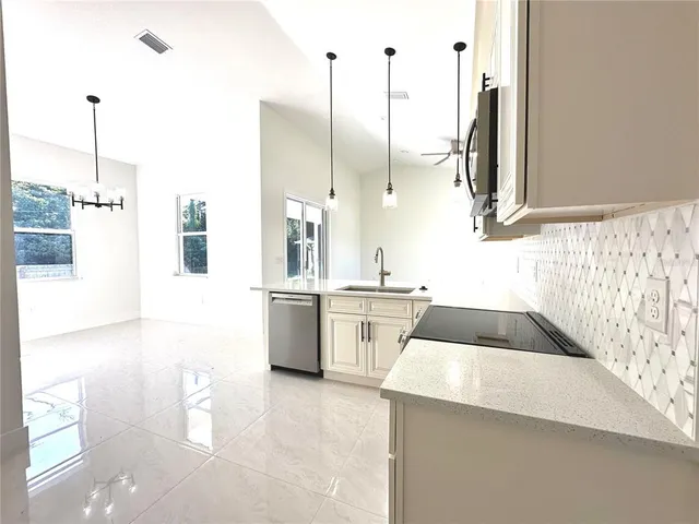 a kitchen with a sink and a stove top oven